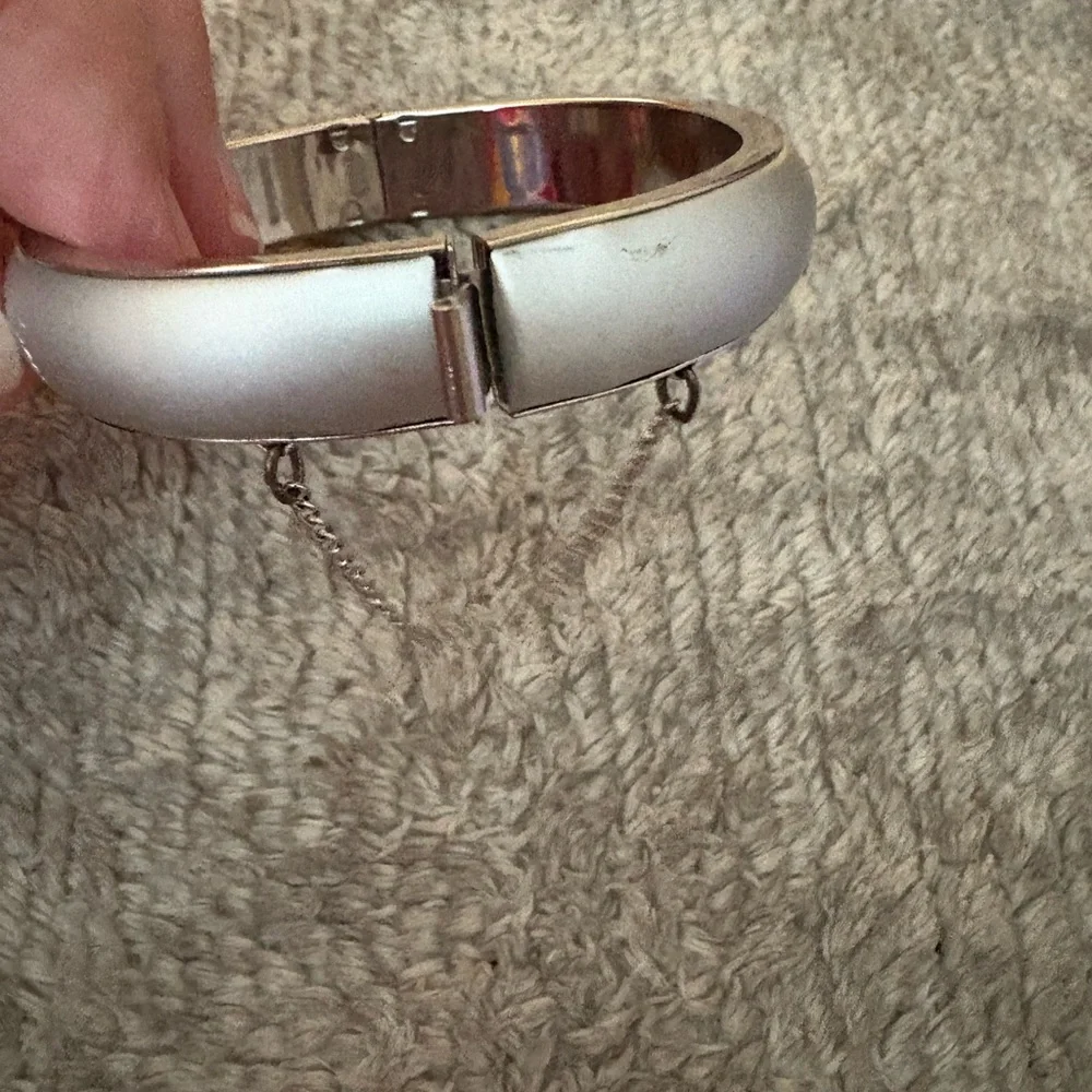 GUC silver tone bangle with safety chain